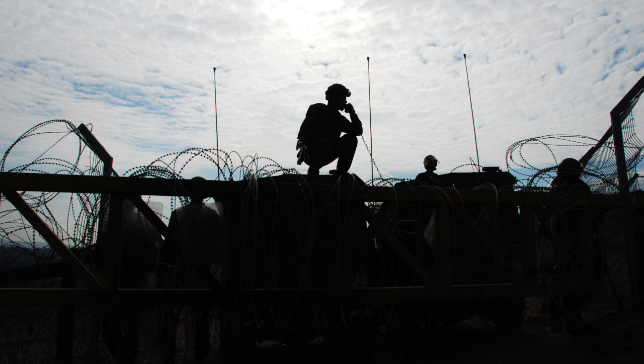 Israeli soldiers guarding a barrier.