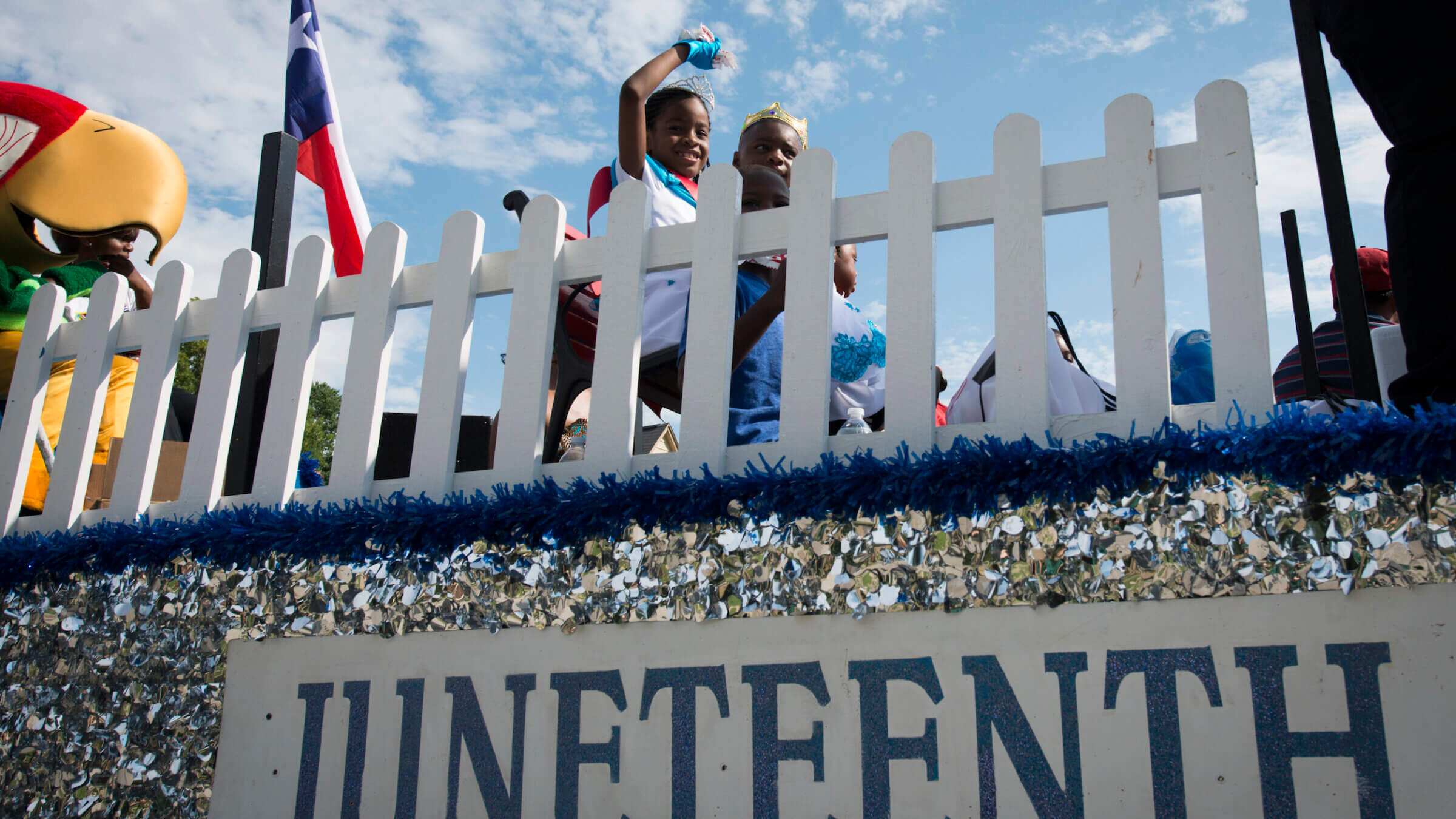 Little Miss Juneteenth Dystiny Johnson, 9, waves from a float during the 39th Annual Juneteenth Parade on Saturday, June 16, 2012, in Houston.