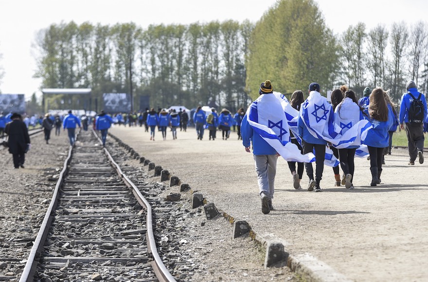 March of the Living participants carrying Israeli flags at the former Nazi Auschwitz-Birkenau concentration camp at Oswiecim in Krakow, Poland, April 24, 2017. 