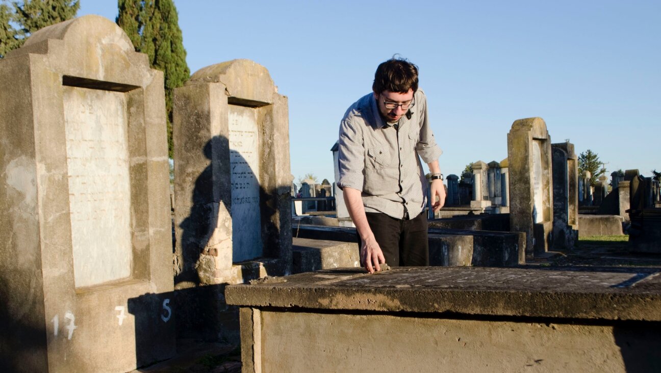 Javier Sinay visits the Jewish cemetery in Moises Ville, Argentina, during a visit to the village in 2013. (Paula Salischiker)
