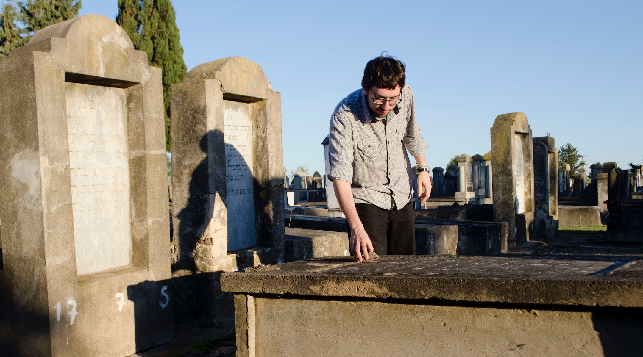 Javier Sinay visits the Jewish cemetery in Moises Ville, Argentina, during a visit to the village in 2013. (Paula Salischiker)