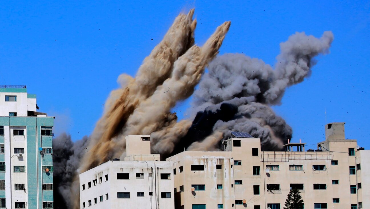 Smoke rises from the Al-Jalaa tower in Gaza City, which housed apartments and several media outlets, including The Associated Press and Al Jazeera, after an Israeli airstrike, May 15, 2021. (Atia Mohammed/Flash90)