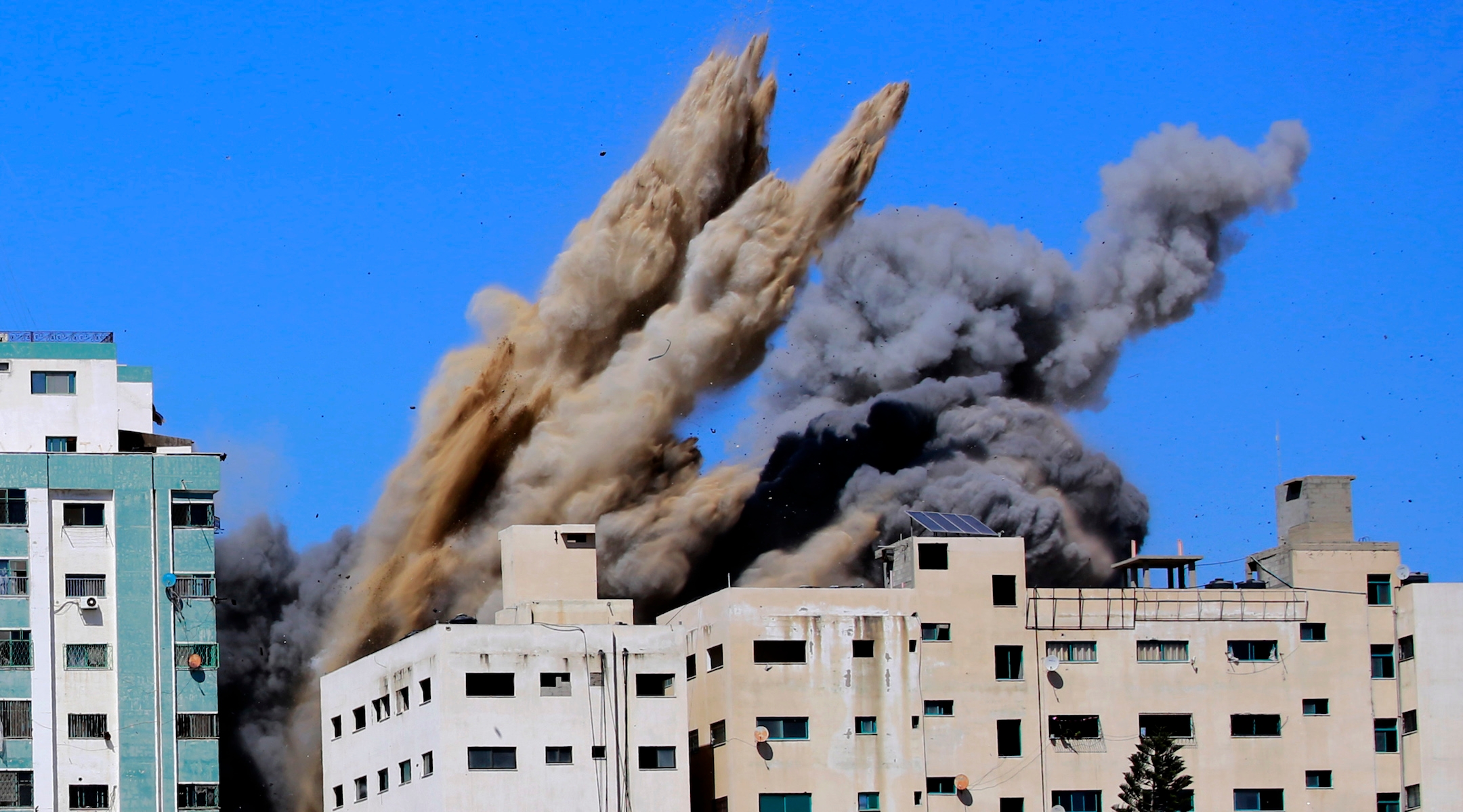 Smoke rises from the Al-Jalaa tower in Gaza City, which housed apartments and several media outlets, including The Associated Press and Al Jazeera, after an Israeli airstrike, May 15, 2021. (Atia Mohammed/Flash90)