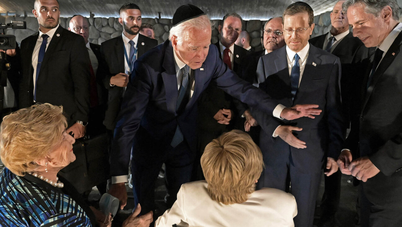 Joe Biden speaks to Holocaust survivors Giselle Cycowicz, right, and Rena Quint, left, during a ceremony at the Yad Vashem Holocaust Memorial museum in Jerusalem, July 13, 2022.