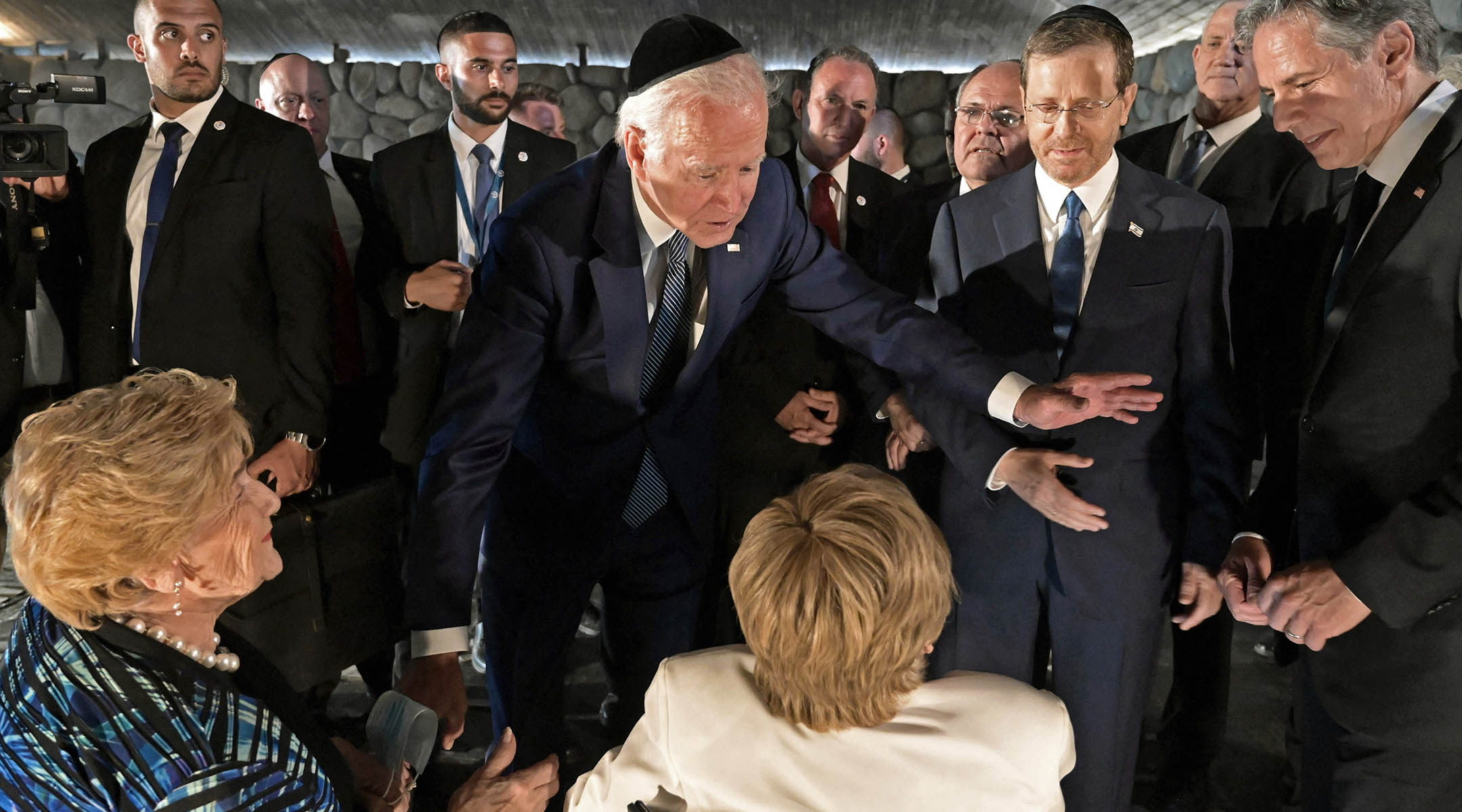 Joe Biden speaks to Holocaust survivors Giselle Cycowicz, right, and Rena Quint, left, during a ceremony at the Yad Vashem Holocaust Memorial museum in Jerusalem, July 13, 2022.