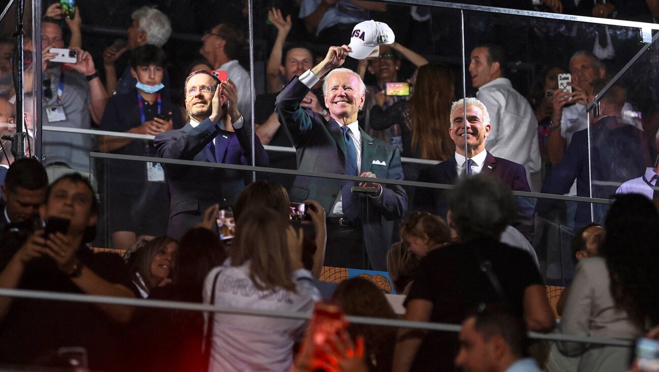 Israeli President Isaac Herzog, President Joe Biden, and Israel’s caretaker Prime Minister Yair Lapid applaud and cheer as they attend the opening ceremony of the Maccabiah Games at Teddy Stadium in Jerusalem, July 14, 2022. (Ronen Zvulun/POOL/AFP via Getty Images)