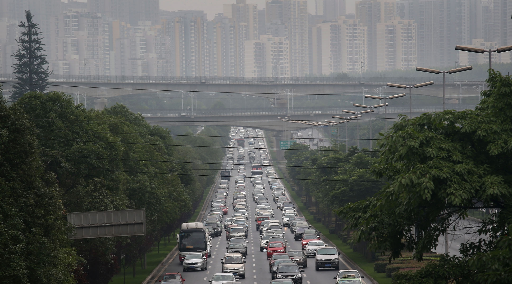 Commuter traffic flows from a skyline of apartment buildings in Chengdu, China, June 30, 2015. (John Moore/Getty Images)
