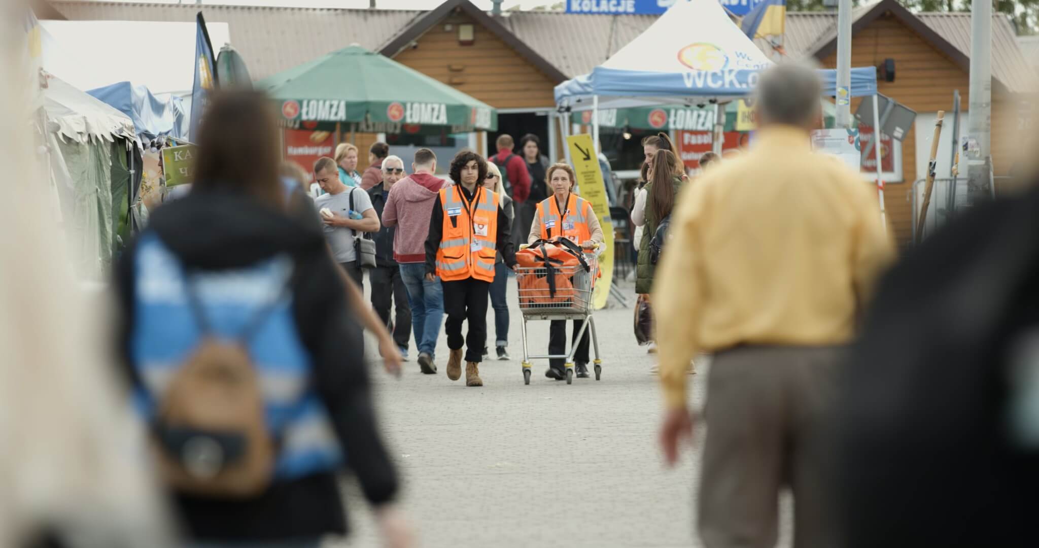 Dr. Paula Rackoff, right, crosses the Ukraine-Poland border, pushing a cart of medical supplies.
