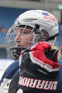 Close up of woman in hockey helmet and uniform