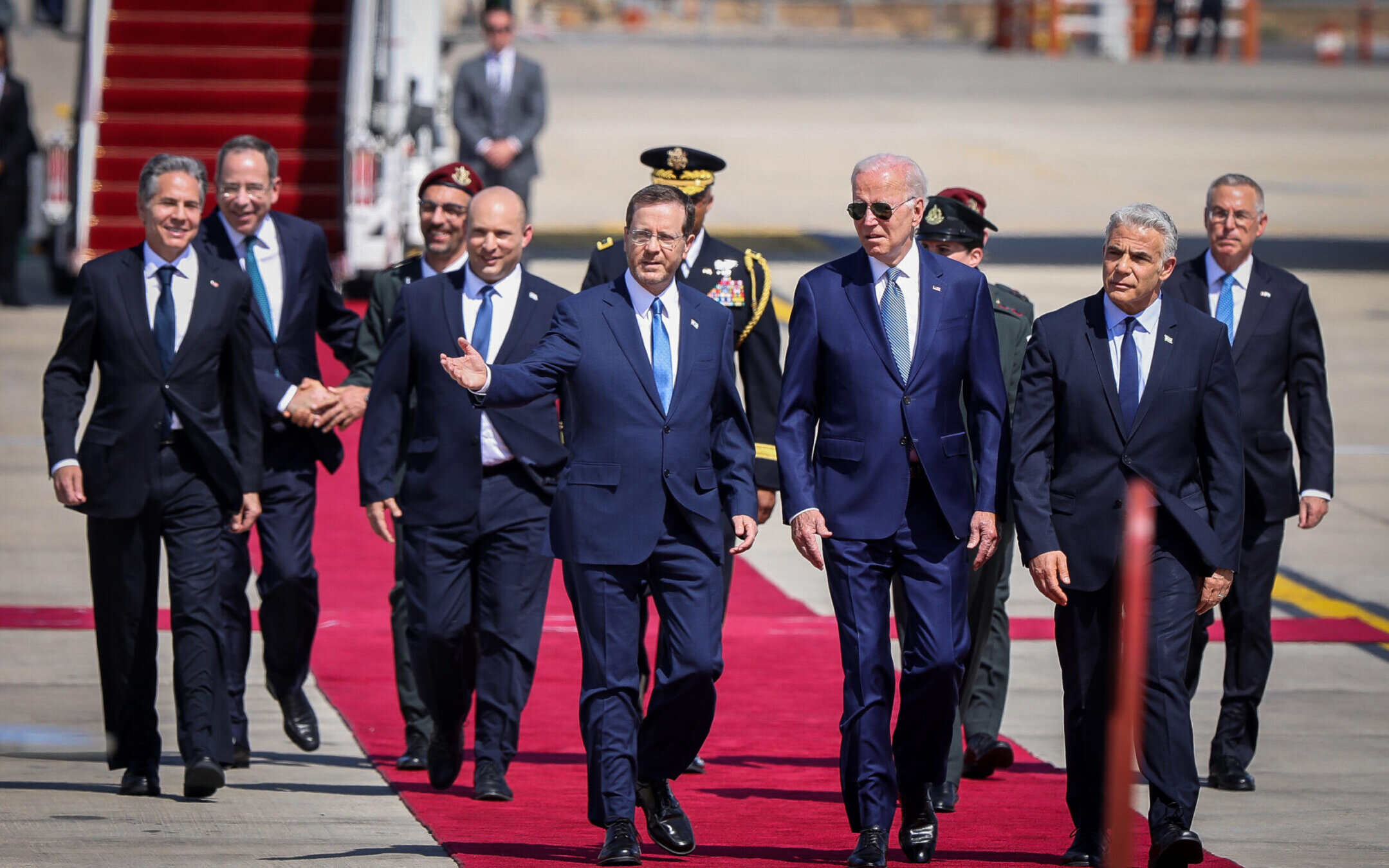 U.S. President Joe Biden, with Israeli Prime Minister Yair Lapid at his left and Israeli President Isaac Herzog on his right at a welcome ceremony at Ben Gurion Airport near Tel Aviv, July 13, 2022. (Noam Revkin Fenton/Flash90)