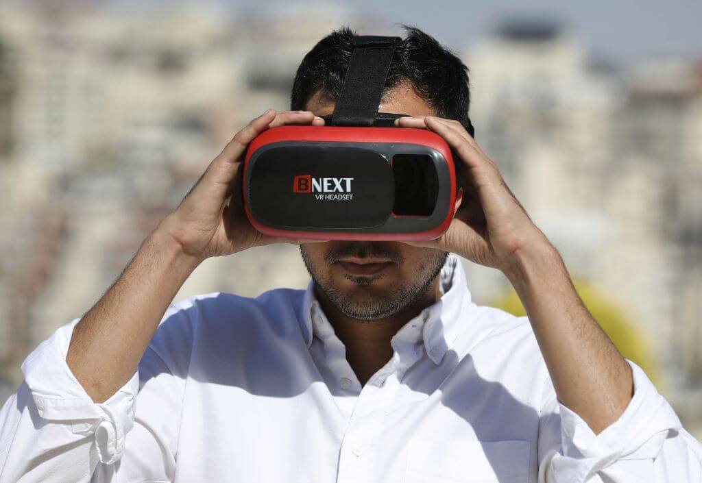 In this 2019 photo, Salem Barameh of the Palestine Institute for Public Diplomacy uses a headset for the "Palestine VR", a new app allowing users to virtually visit key Palestinian sites.