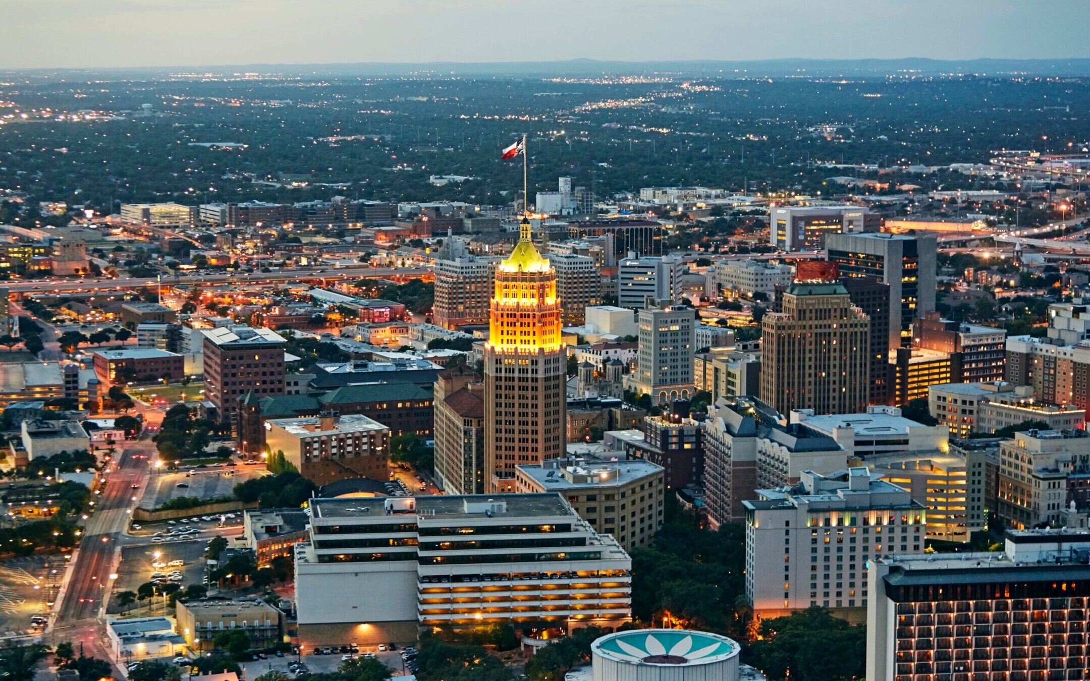 Aerial view of downtown San Antonio illuminated at dusk. (Getty Images)