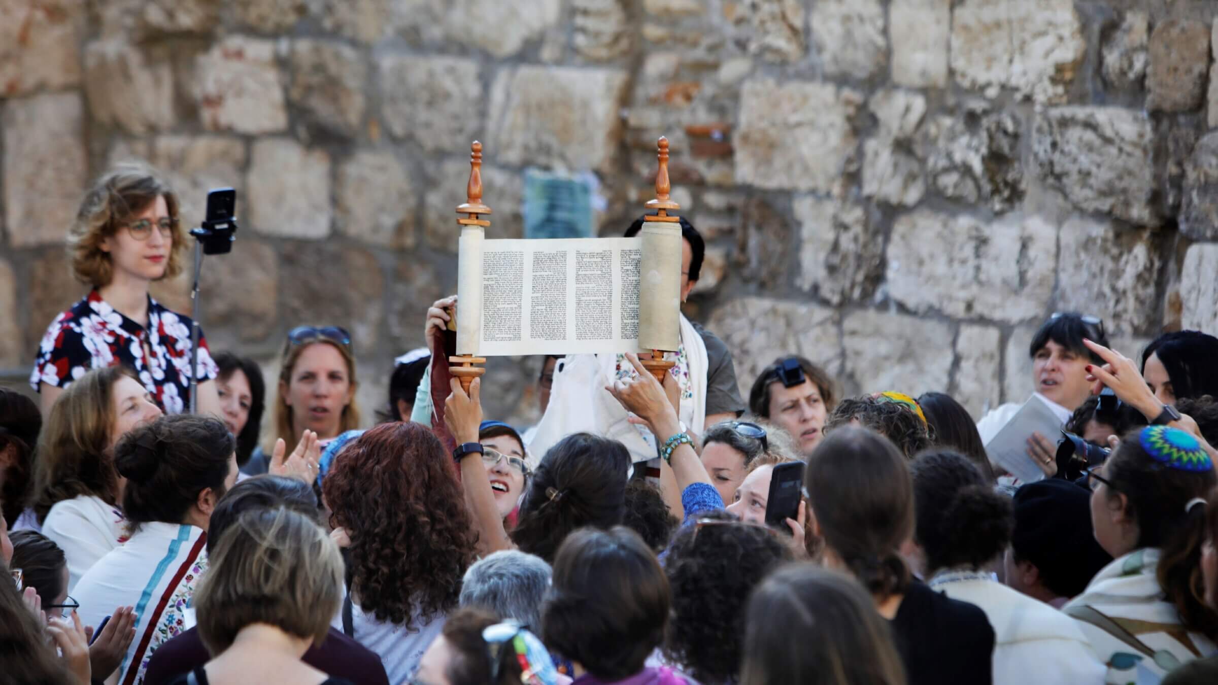 Members of the liberal Jewish religious group Women of the Wall hold up the Torah scroll during a morning prayer on August 23, 2017. 