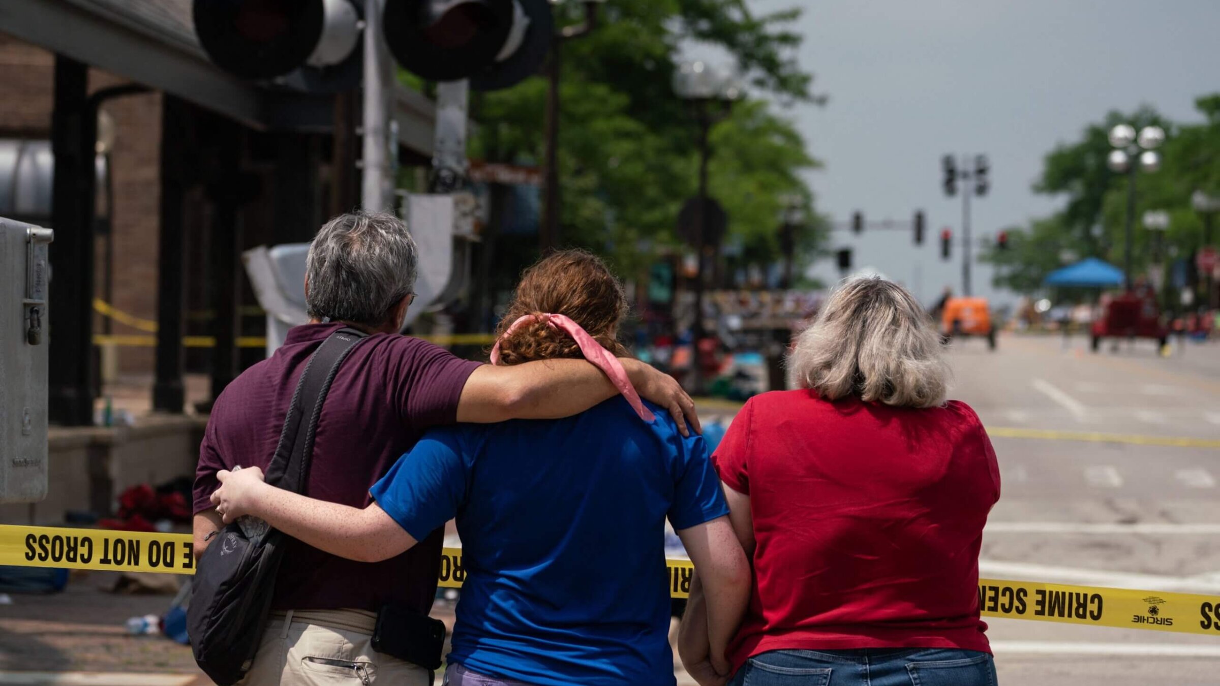 A family embraces each other the day of a mass shooting at a July 4th parade in downtown Highland Park, Illinois.