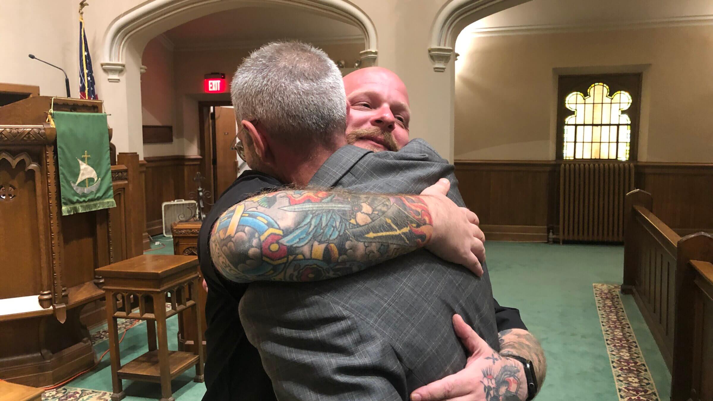 The Rev. Quincy Worthington, of the Highland Park Presbyterian Church, hugs event co-planner the Rev. Bryan Cones of Trinity Episcopal Church at the conclusion of the interreligious community vigil Tuesday night.