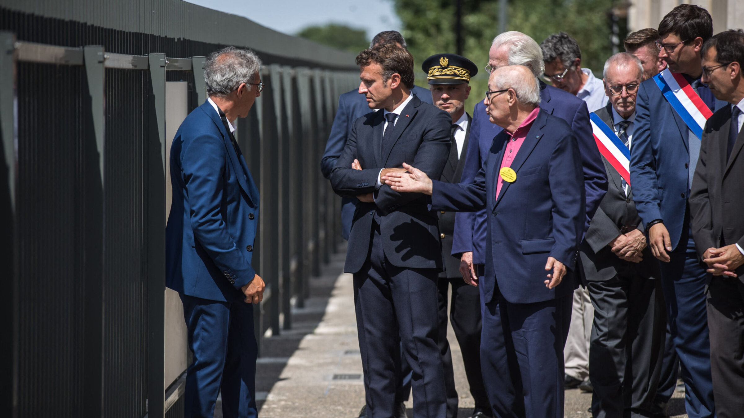 French President Emmanuel Macron, crossing his arms, visits the Pithiviers Holocaust museum in France, July 17, 2022. (Christophe Petit Tesson/Pool/AFP via Getty Images)