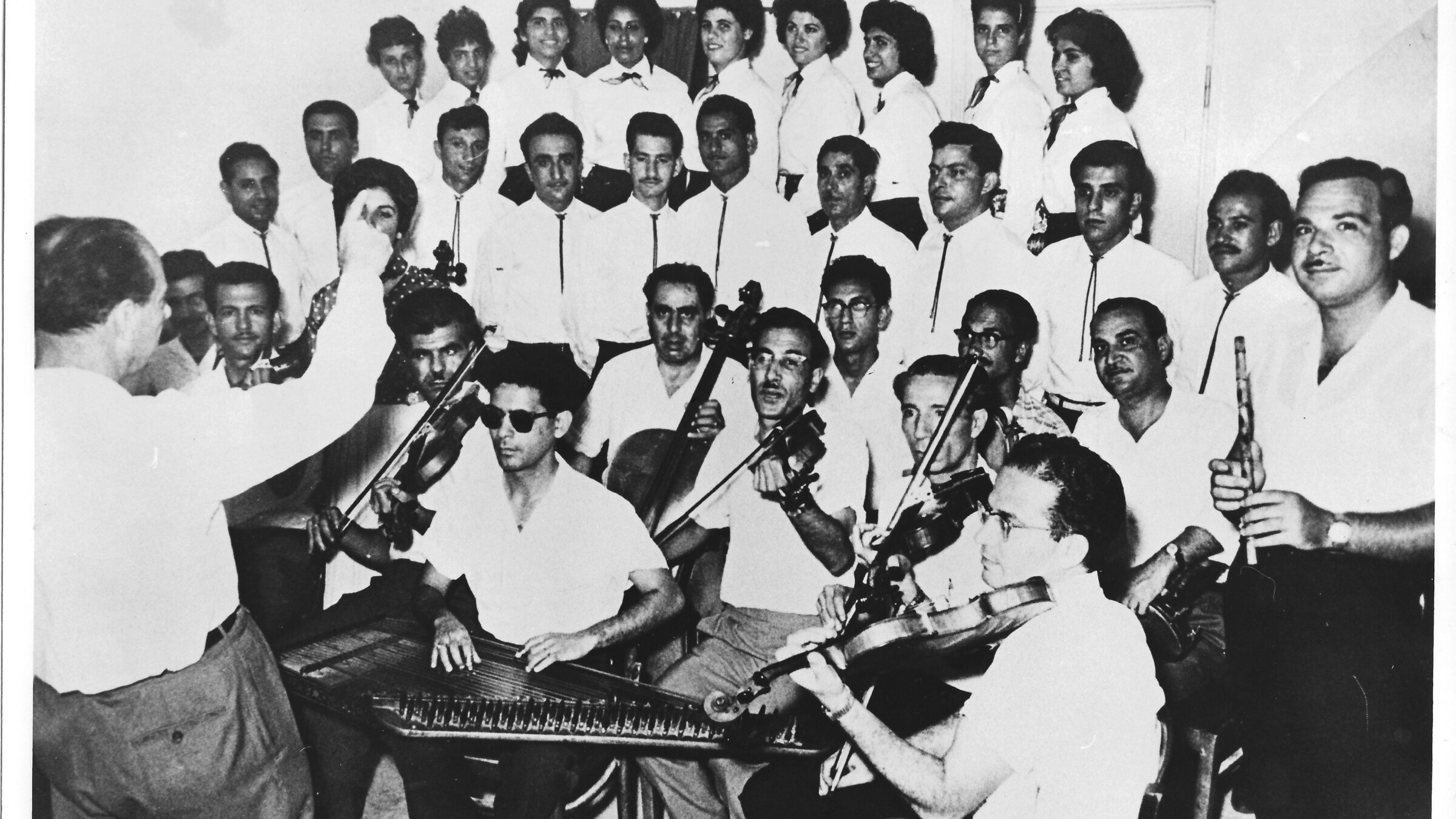 Avraham Salman (with dark glasses, center, bottom row) and the Israel Broadcasting Authority Orchestra rehearsing in the studio, circa 1959.