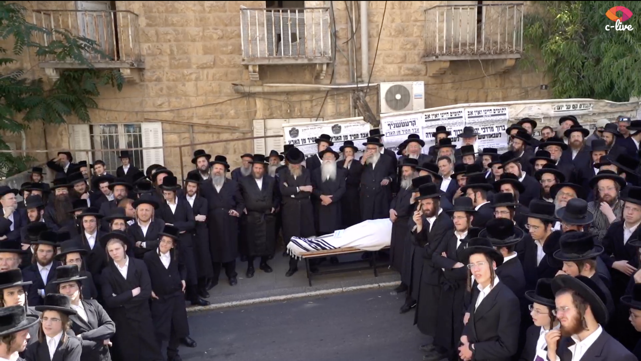 The body of Baruch Lebovits, a convicted child abuser, is visible at his funeral in Jerusalem, July 4, 2022. (Screenshot from livestream)
