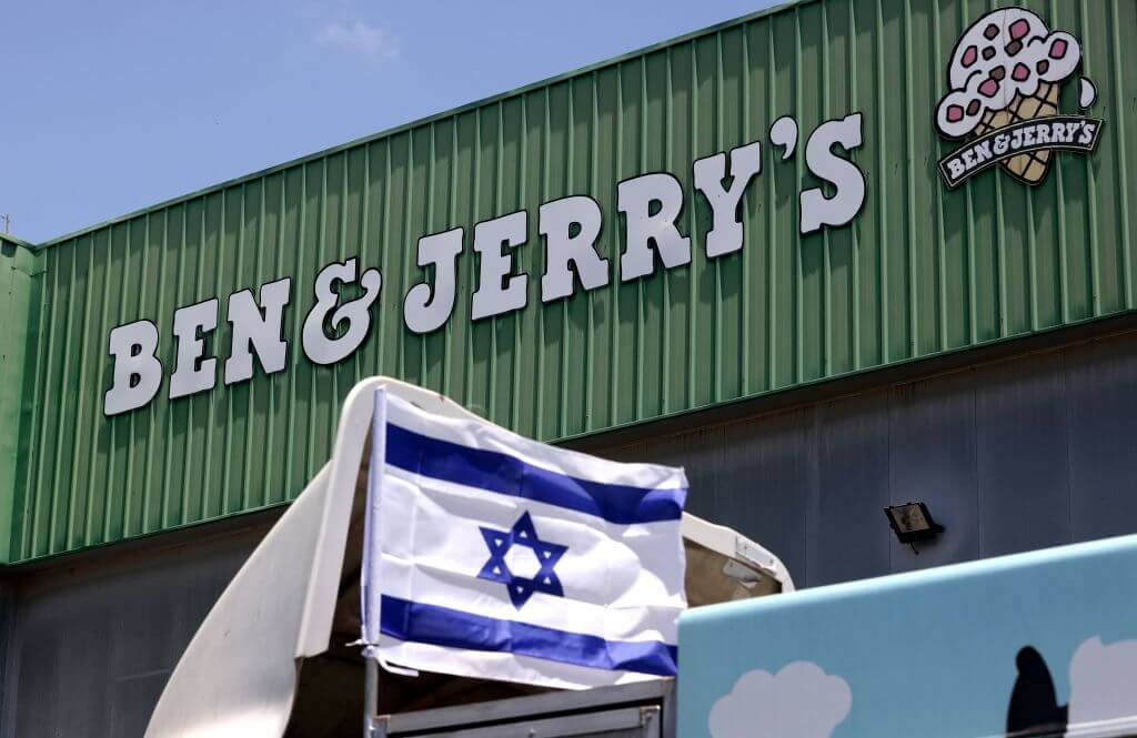An Israeli flag is set atop a delivery truck outside US ice-cream maker Ben & Jerry's factory in Be'er Tuvia, on July 21, 2021. 