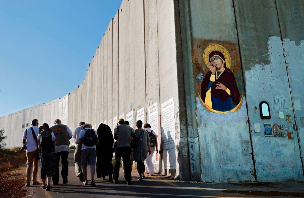 An icon of Virgin Mary painted on Israel's controversial separation barrier, which divides the West Bank from Jerusalem, on July 7, 2017 in the biblical town of Bethlehem. 
