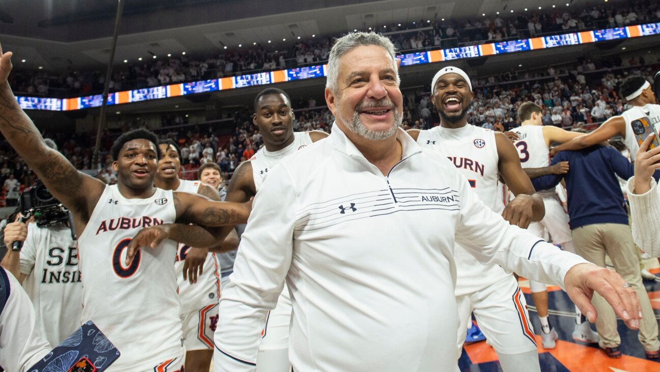 Bruce Pearl celebrates with his team after defeating the Alabama Crimson Tide at Auburn Arena, Feb. 1, 2022. (Michael Chang/Getty Images)