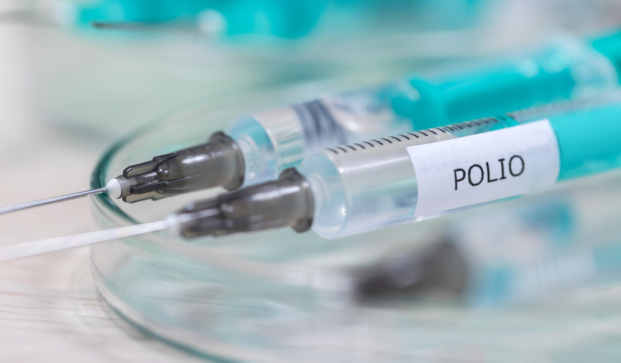 An image of a syringe labelled "polio."