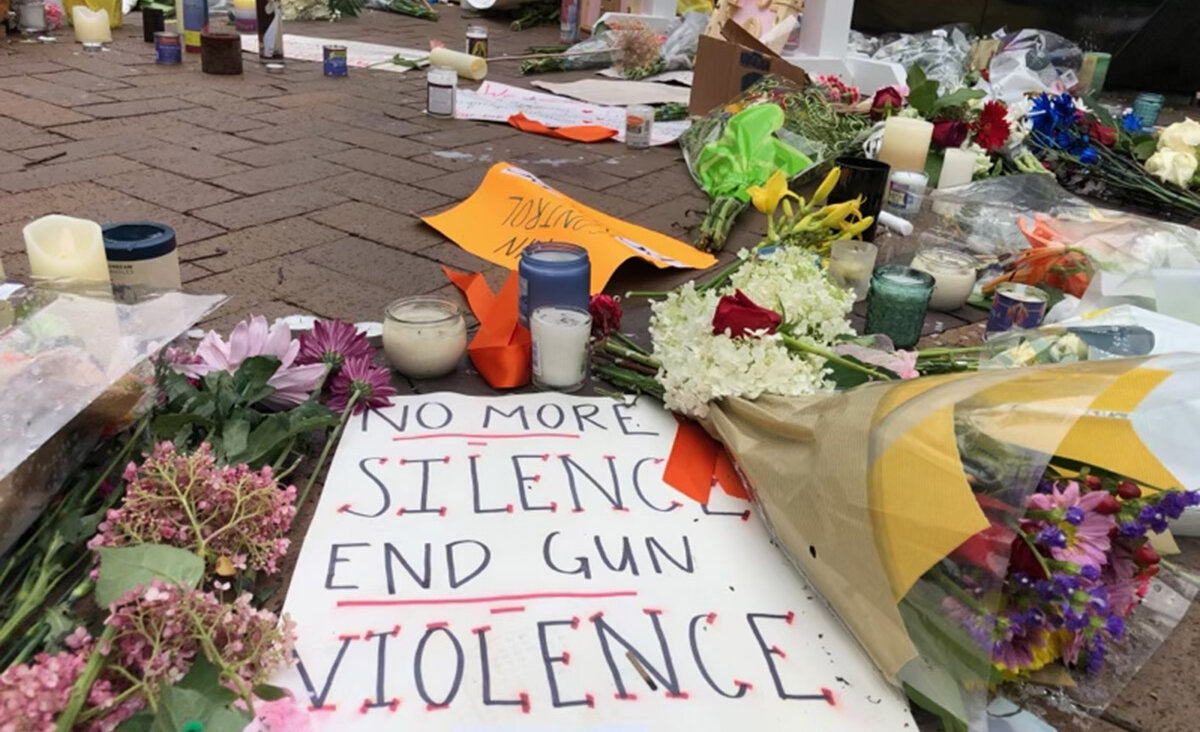 Signs against gun violence are placed at a memorial for the victims of a mass shooting at a Fourth of July parade, on July 6, 2022 in Highland Park, Illinois.