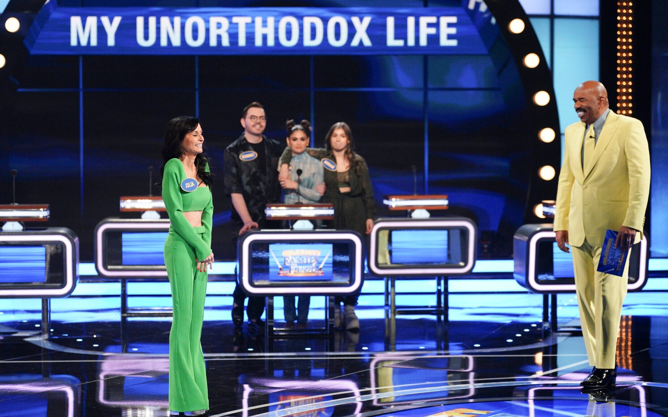 Julia Haart and her family compete on “Celebrity Family Feud,” hosted by comedian Steve Harvey, Aug. 14, 2022. (ABC/Christopher Willard)