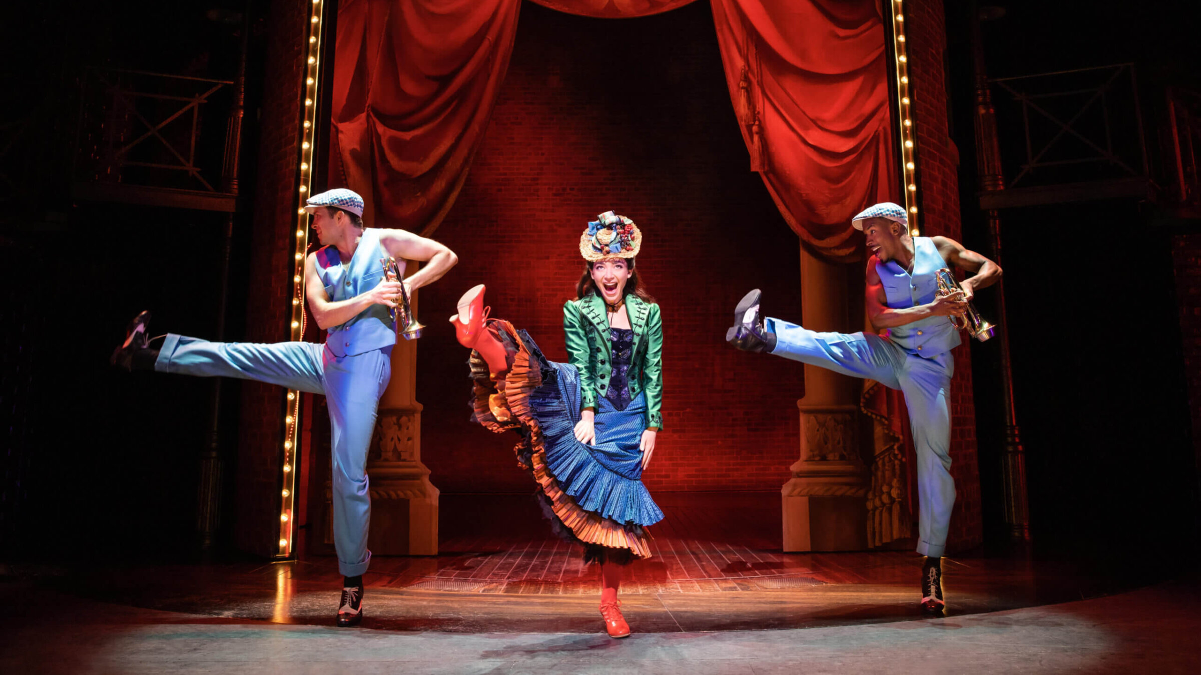 Julie Benko onstage, high-kicking as Fanny Brice.