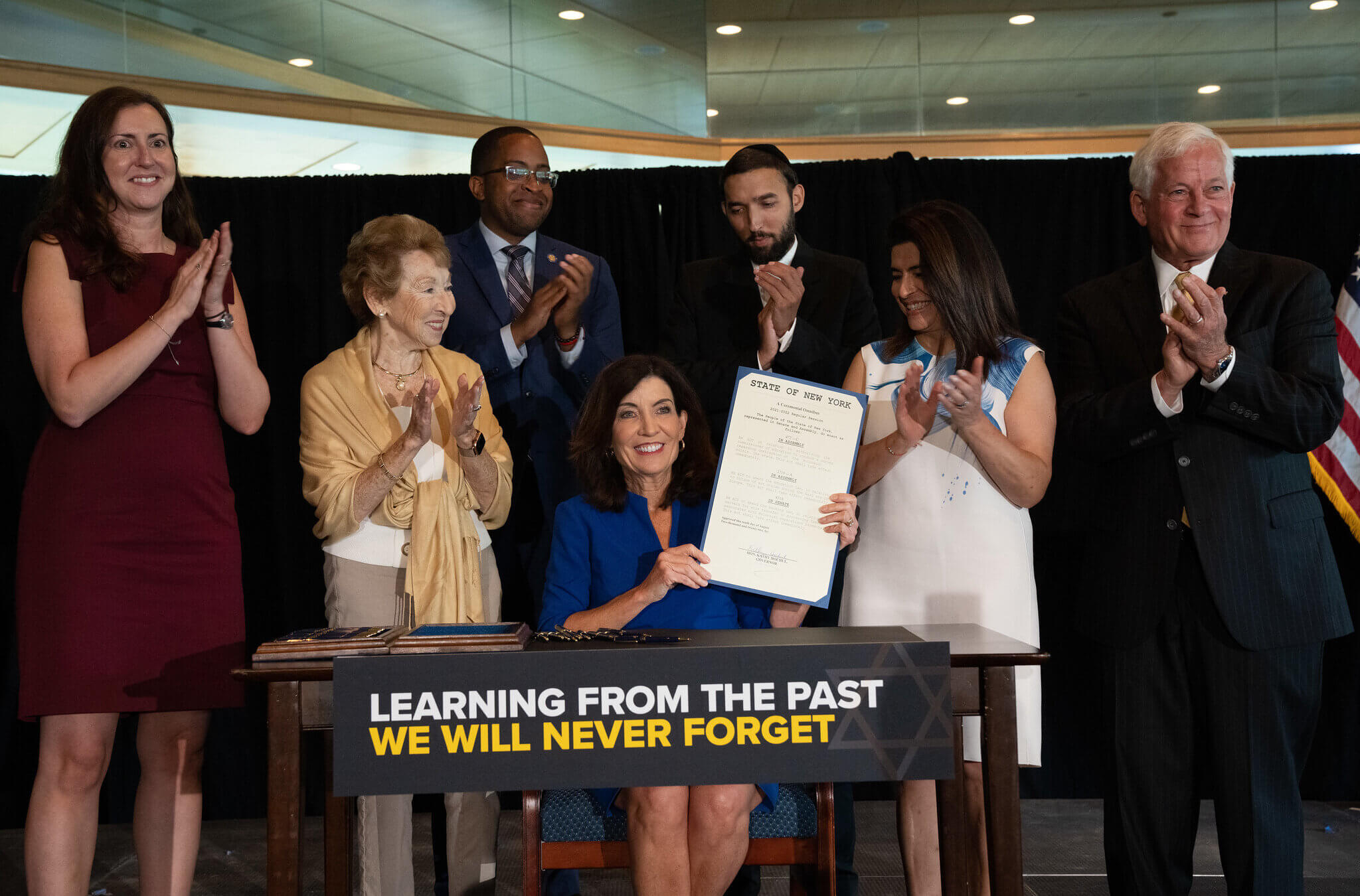 Gov. Kathy Hochul signs a legislative package to support Holocaust survivors in educational, cultural and financial institutions on Aug. 10, 2022.