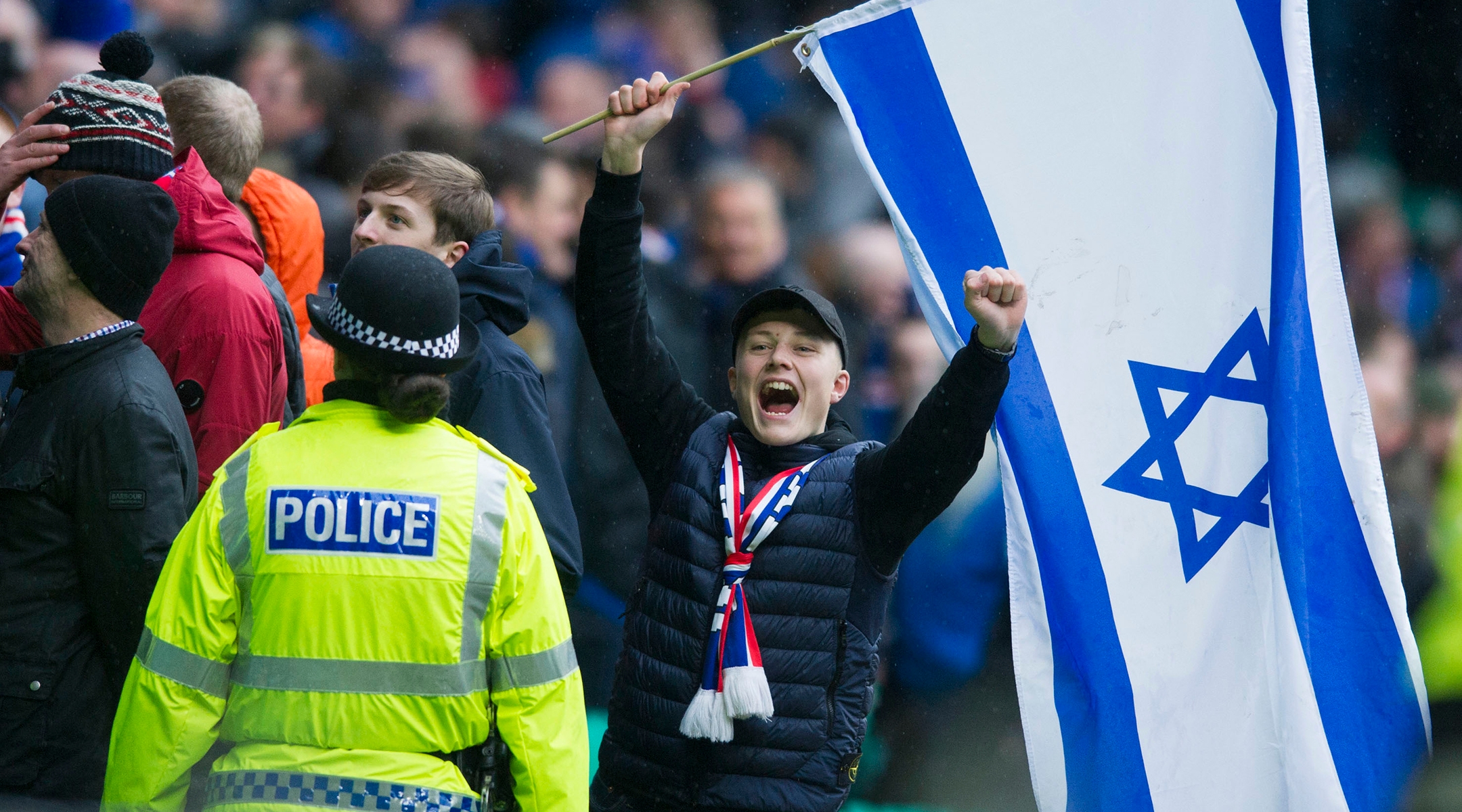 A Rangers FC fan celebrates while holding an Israeli flag during a match against Celtic FC in 2017. (Ross MacDonald/SNS Group via Getty Images)