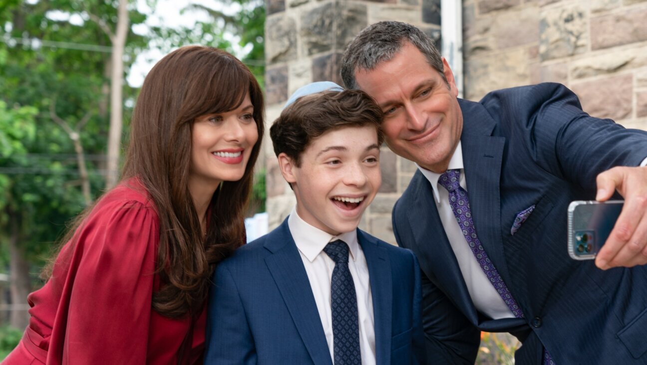 Eli Golden, center, stars in “13: The Musical,” a Netflix movie that features Debra Messing and Peter Hermann as his parents. (Alan Markfield/Netflix)