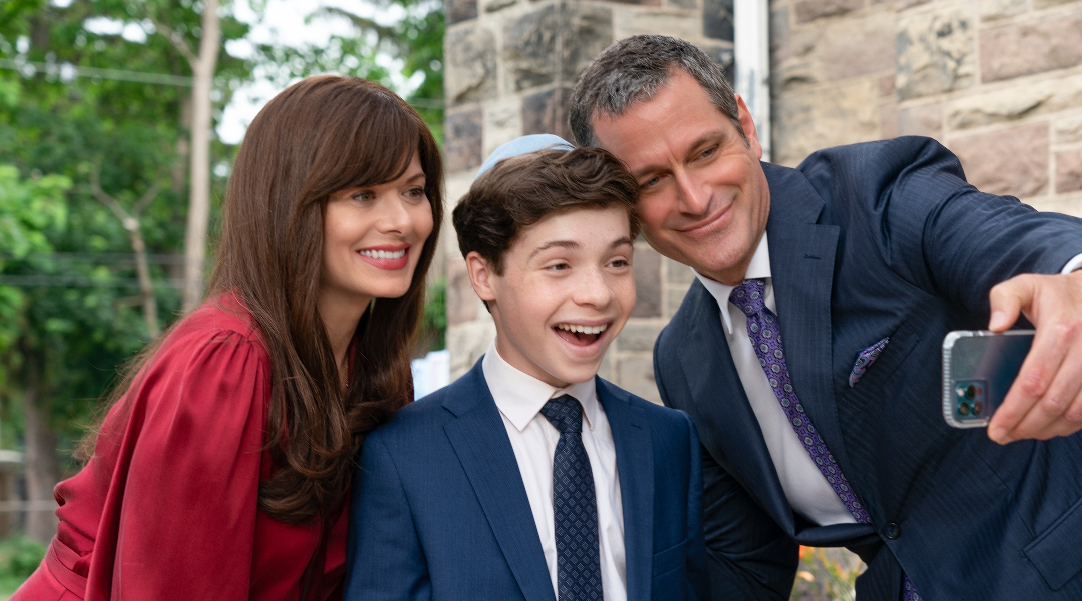 Eli Golden, center, stars in “13: The Musical,” a Netflix movie that features Debra Messing and Peter Hermann as his parents. (Alan Markfield/Netflix)