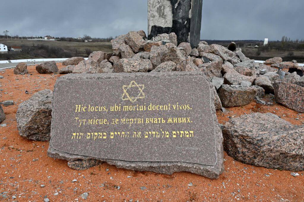 A plaque at the Menorah memorial at the entrance of the Drobitsky Yar Holocaust memorial complex in the eastern outskirts of Kharkiv, set on the place of a mass killing of Jewish people by Nazis during WWII, on March 27, 2022, a day after it was damaged in a Russian shelling.
