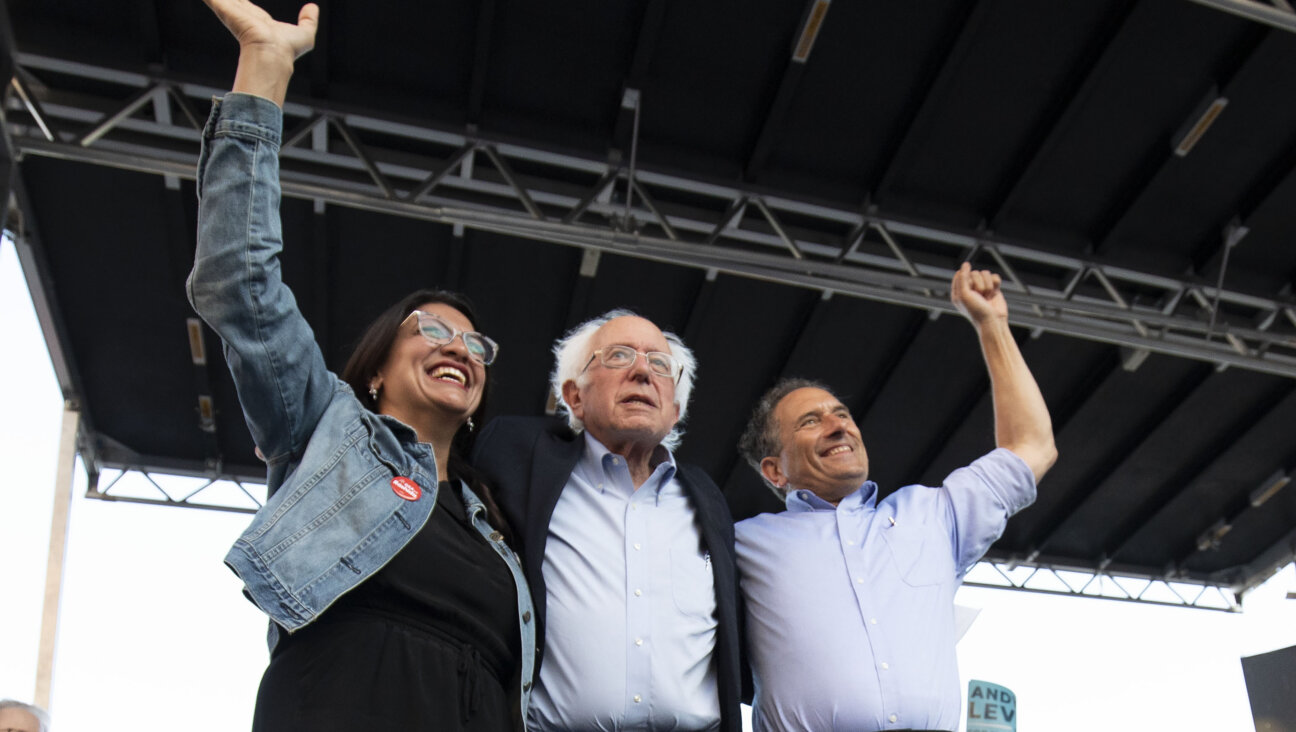 Senator Bernie Sanders, I-Vt., center, campaigns for Michigan Democratic Rep. Andy Levin, right, and Rep. Rashida Tlaib, left, at a rally on July 29, 2022.