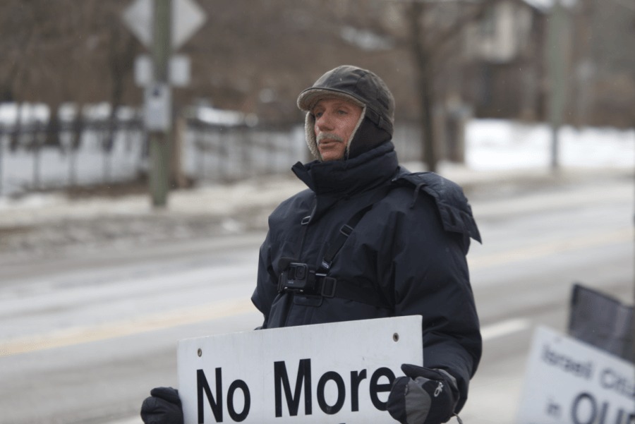 Henry Herskovitz holds a sign saying 'No More Holocaust Movies' outside a Michigan synagogue in 2021. (Courtesy)
