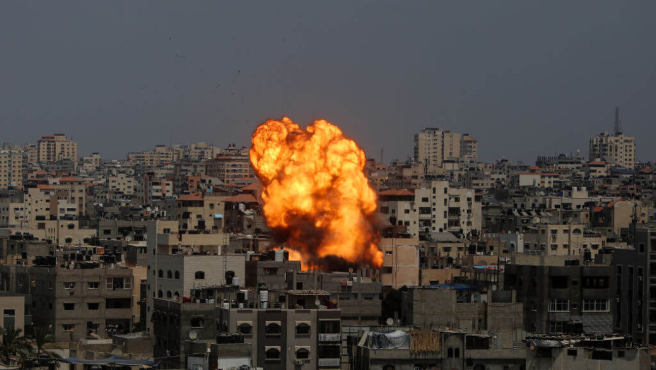 Flames and smoke rise from a residential building following an Israeli airstrike on Aug. 6, 2022 in Gaza City, Gaza. 