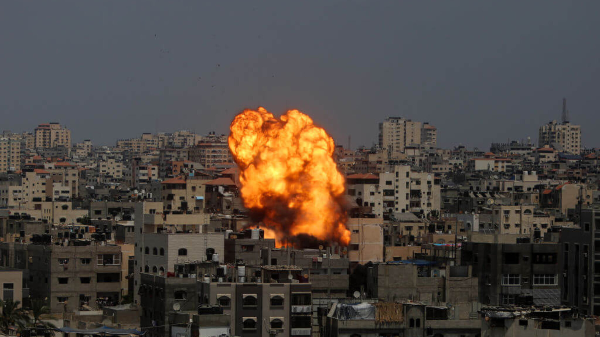 Flames and smoke rise from a residential building following an Israeli airstrike on Aug. 6, 2022 in Gaza City, Gaza. 