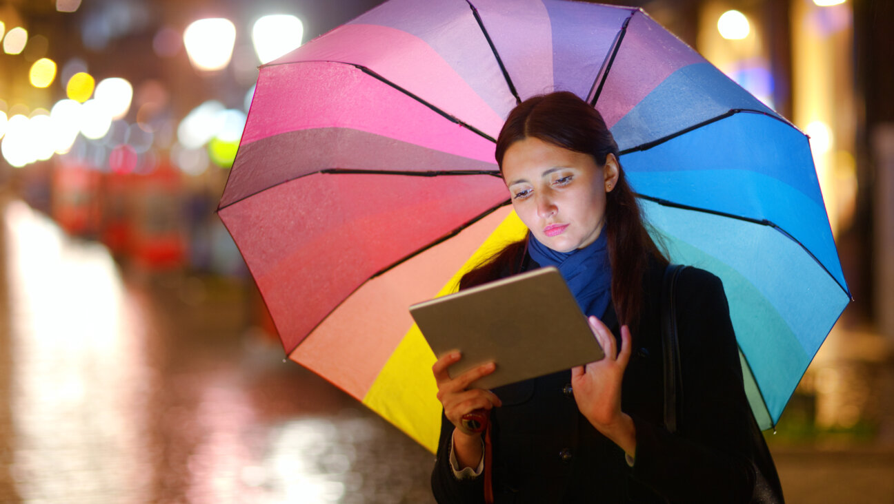 Is this woman disappointedly writing a negative hotel review during a rainstorm?
