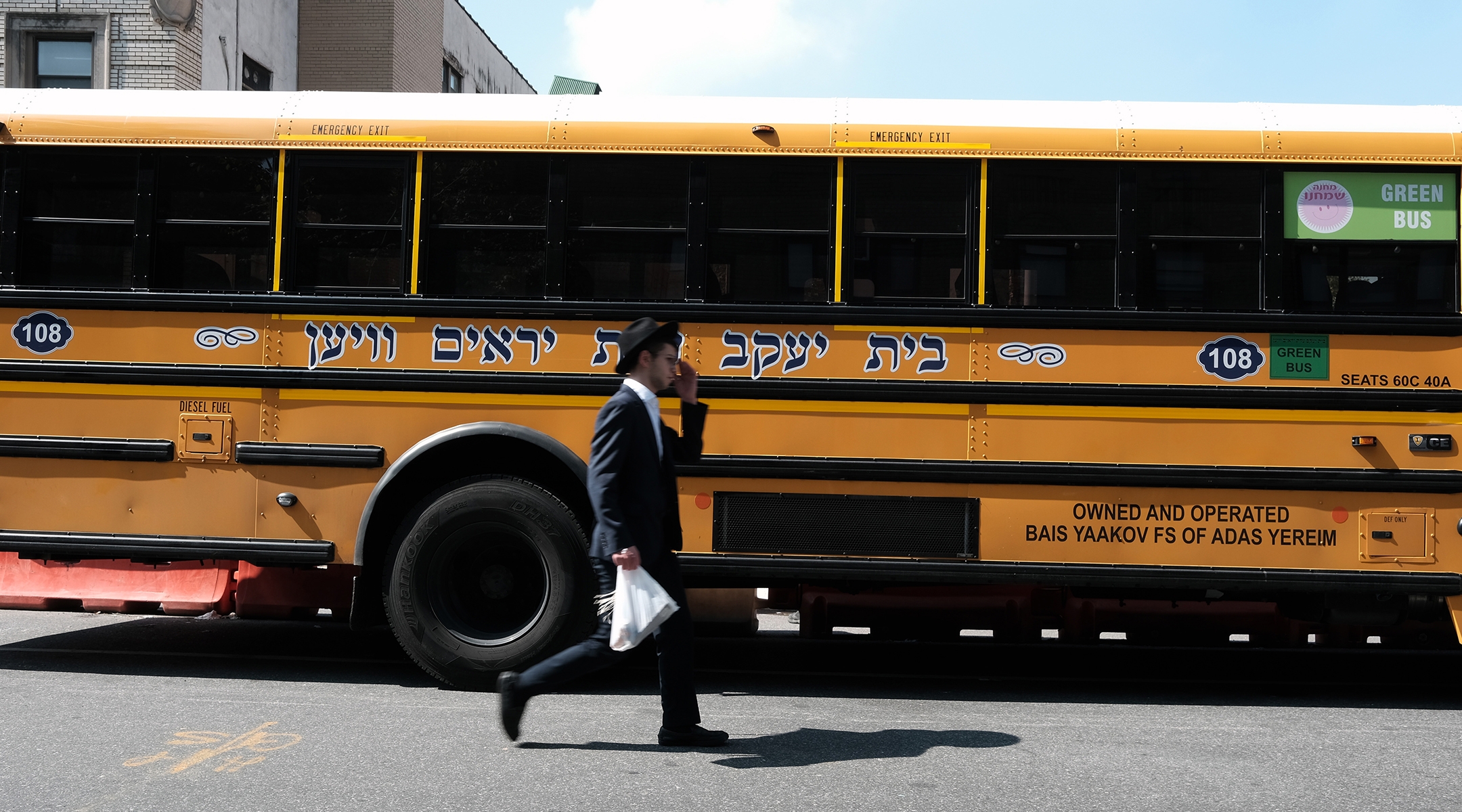 A yeshiva school bus drives through Borough Park, Brooklyn.