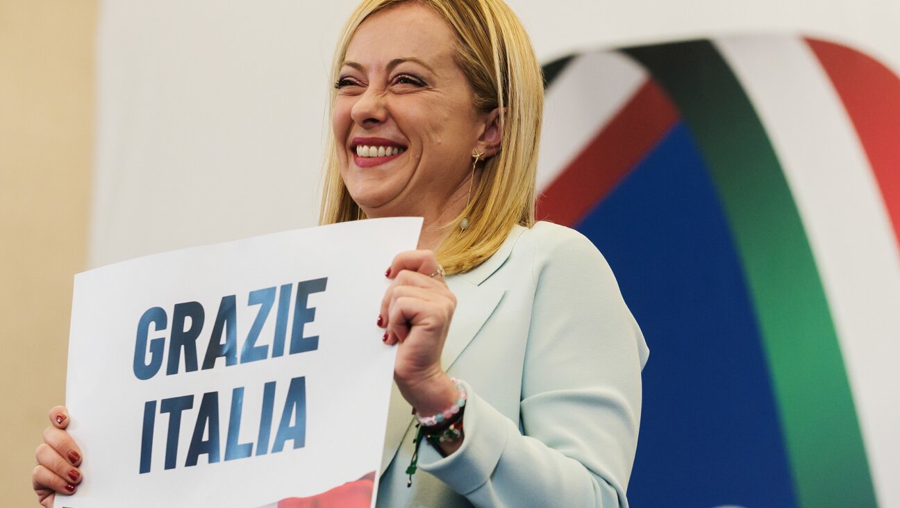 Giorgia Meloni is seen holding a placard quoting “Thanks Italy” in a press room in Rome, Sept. 26, 2022. (Valeria Ferraro/SOPA Images/LightRocket via Getty Images)