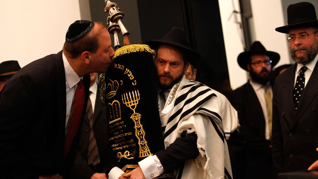 A man kisses a Torah during the official opening ceremony of a new synagogue in Speyer, Germany. 
