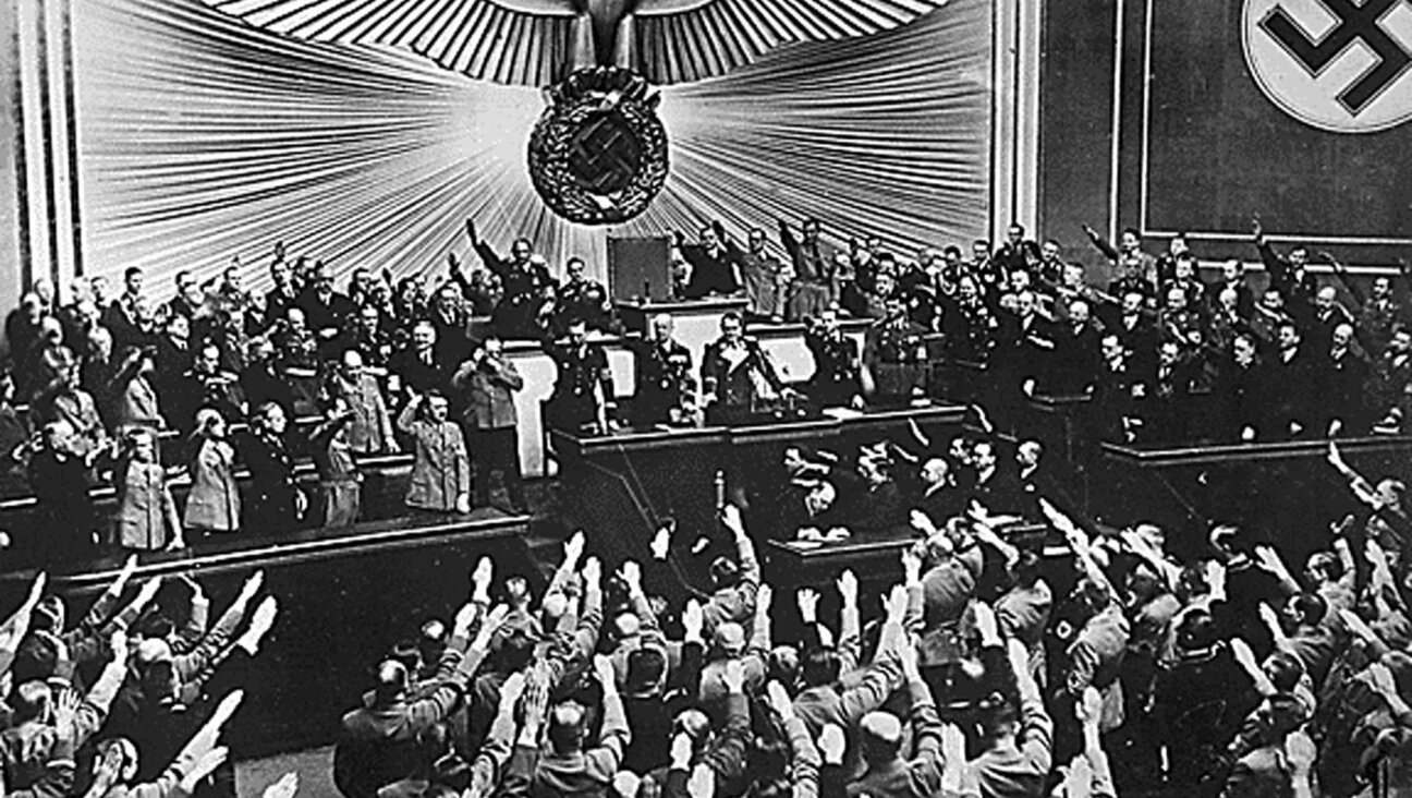 Adolf Hitler receives a one-handed ovation from the Reichstag.