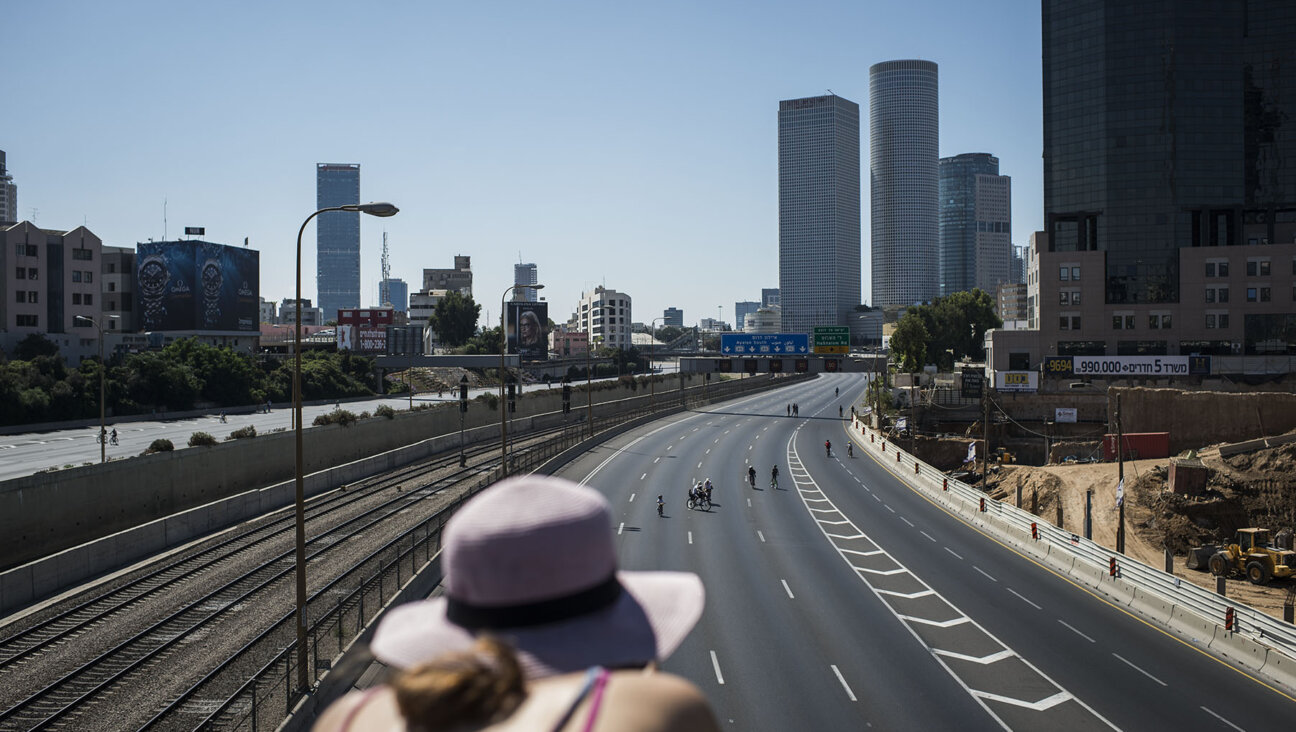 People ride bicycles in the middle of carless roadways in Tel Aviv on Yom Kippur 2014.