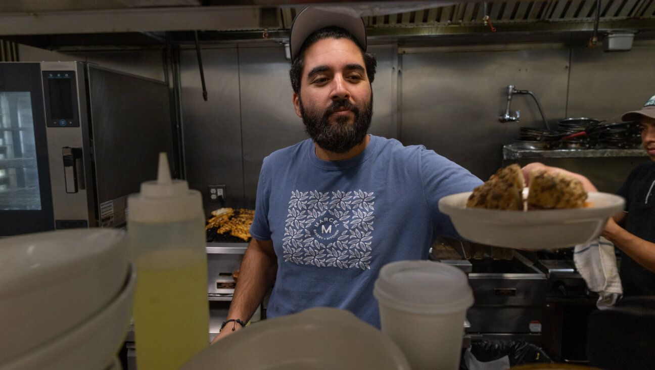 Meny Vaknin, chef and owner of the Israeli cafe Marcel, serves up his signature bagel sandwich: "The Committed Jew." 