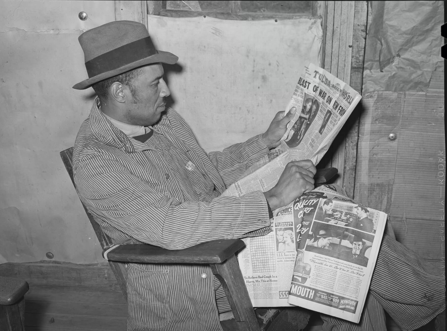 An Oklahoma farmer reads a newspaper.