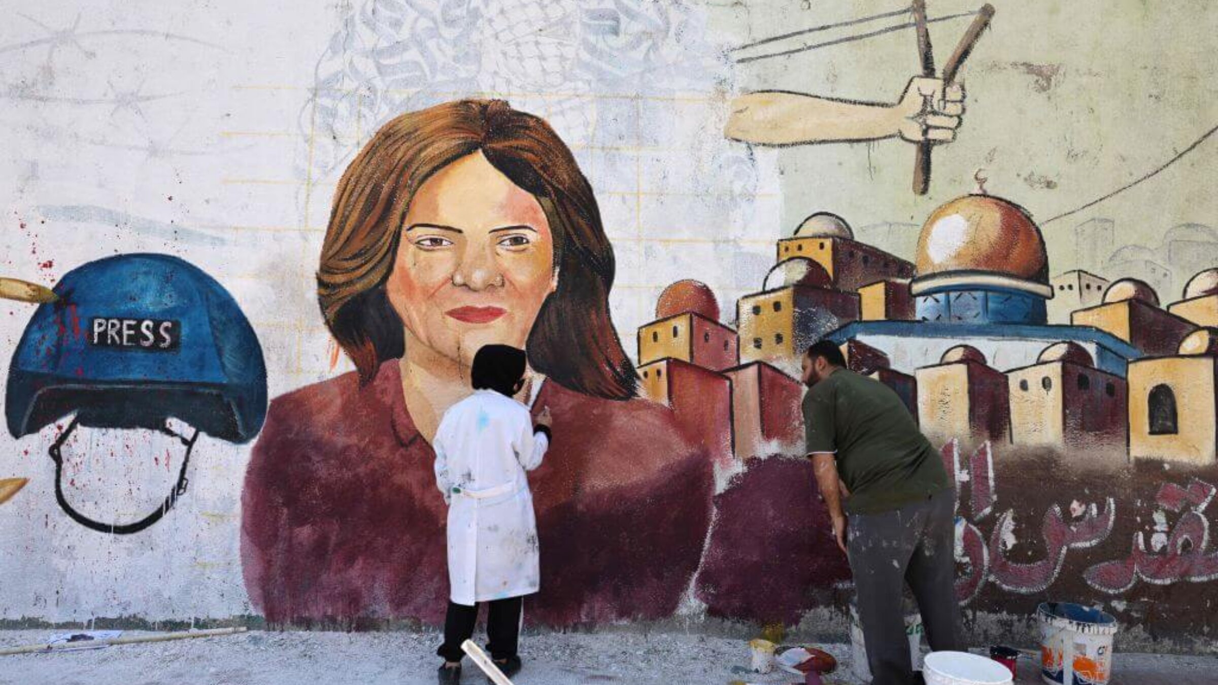 Palestinian artists paint a mural in honor of slain veteran Al-Jazeera journalist Shireen Abu Akleh in Gaza City on May 12, 2022. 