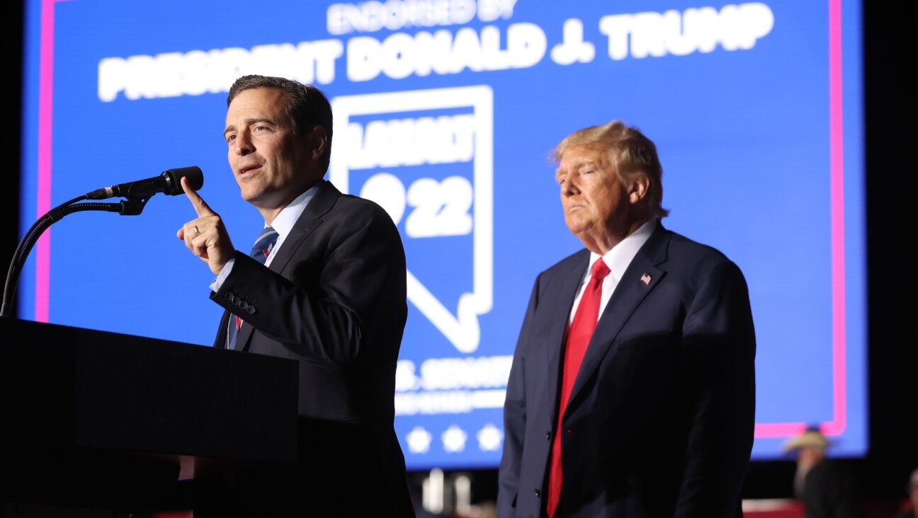 Nevada Republican U.S. Senate candidate Adam Laxalt joins former U.S. President Donald Trump on stage during a campaign rally at Minden-Tahoe Airport in Minden, Nevada, Oct. 08, 2022. (Justin Sullivan/Getty Images)