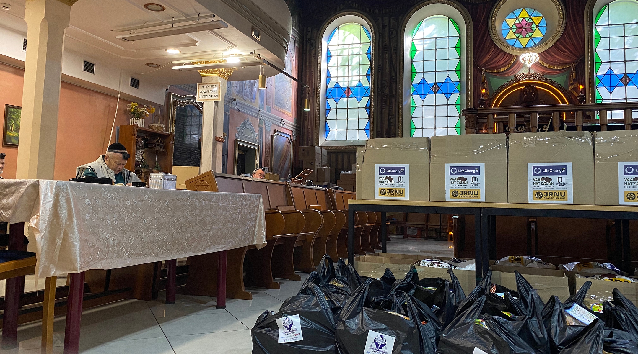 Food parcels, ready to be delivered to Jews in Lviv, are piled up waiting until the end of morning prayers before they can be ferried out to those waiting outside. (Jacob Judah)