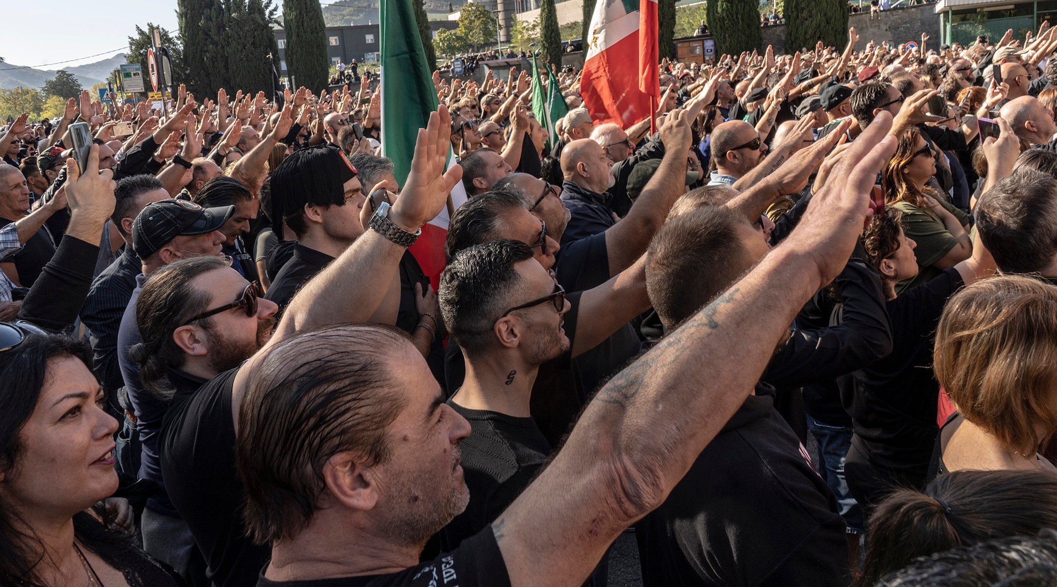 Fascist sympathizers do the Saluto Romano outside the cemetery of San Cassiano, where Benito Mussolini is buried, as Italians mark one hundred years after Mussolini’s March on Rome in Predappio, Italy, Oct. 30, 2022. (Francesca Volpi/Getty Images)